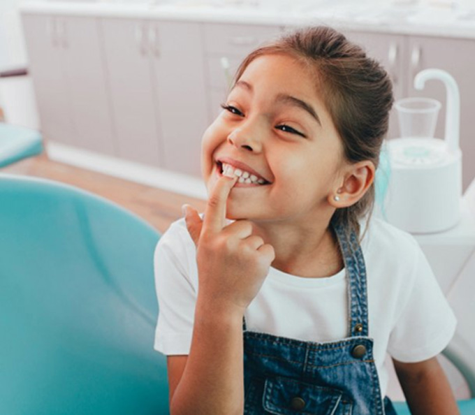 a child patient smiling during her dental visit