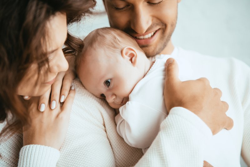 parents holding and soothing their baby